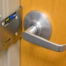 Image of Safe-Latch fast lockdown device in use on out-swing classroom door or office door.